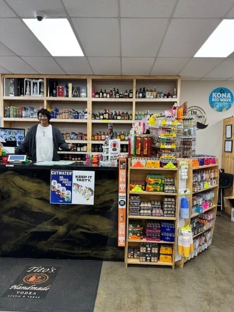 Friendly Hefner Liquors staff at the checkout counter